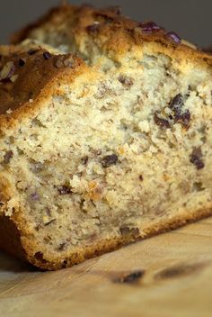 a loaf of banana bread sitting on top of a wooden cutting board