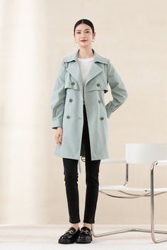 Elevate your style with our Tender Green Trench Coat, crafted from a high-quality PET fabric with a soft, cotton-like texture. This coat's low-saturation hue and classic H-line silhouette combine to offer a modern, urban chic look. Designed with sleek cuffs and a versatile mid-length, it's ideal for any height and perfect for adding elegance to your everyday ensemble. Double-breasted Cotton Outerwear, Elegant Solid Color Cotton Outerwear, Cotton Outerwear For Office In Fall, Spring Long Coat With Hidden Button Closure, Spring Double-breasted Solid Pea Coat, Cotton Long Coat With Double Button Closure, Spring Workwear Pea Coat In Solid Color, Double-breasted Cotton Office Outerwear, Cotton Outerwear With Double Button Closure For Office Wear