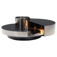 an open fire place with a black top and silver base