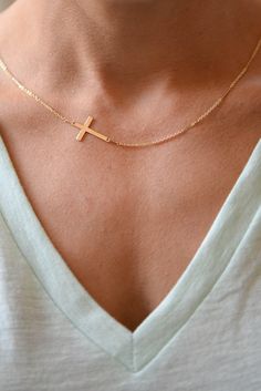 "I am obsessed with this necklace. I have been a long time fan of a classic gold cross necklace....a simple and classic daily wear. In my attempt to edge it up bit, I anchored a lovely Gold Filled Cross Pendant Sideways. The cross measures 9.5 mm by 17 mm (FYI-for reference 1 inch = 24.6 mm) and is strung on my Gold Filled Shimmer Bar Chain. So precious! Feminine and delicate, this is my go to necklace and the perfect gift. Also available with a bolder cross that measures 14.5 mm x 22.4 mm! Phot Dainty Cross Necklace For Everyday Wear, Minimalist Crucifix Jewelry With Delicate Chain, Everyday Minimalist Cross Pendant Necklace, Minimalist Daily Wear Cross Pendant Necklace, Minimalist Everyday Cross Necklace, Minimalist Cross Pendant Necklace For Everyday, Minimalist Cross Pendant Necklace For Everyday Wear, Simple Cross Jewelry With Delicate Chain, Simple Necklace With Delicate Chain And Cross Pendant