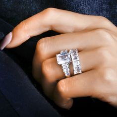 a woman's hand with two rings on top of her finger and the other one is