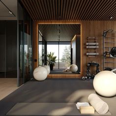 there is a room with yoga mats and exercise balls on the floor in front of a large window