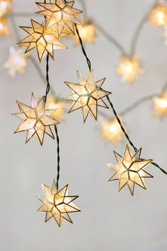 star shaped lights are hanging from a wire