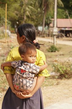 a woman holding a child in her arms