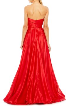 A satiny siren-shaded gown will cause a stir with a very swishy skirt and a strapless silhouette. 61" length Strapless Lined 100% polyester Spot clean Imported Asian Owned/Founded Floor-length Evening Dress With Satin Lining, Strapless Satin Dress With Ruched Bodice For Formal Events, Formal Strapless Satin Dress With Ruched Bodice, Formal Strapless Dress With Fitted Bodice In Taffeta, Formal Strapless Taffeta Dress With Fitted Bodice, One Shoulder Pleated Bodice Prom Gown, One-shoulder Prom Gown With Pleated Bodice, One Shoulder Prom Gown With Pleated Bodice, Red Fitted Bodice Dress With Satin Finish