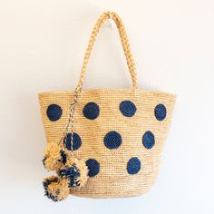 IN STOCK FAST SHIPPING FROM LOS ANGELES Make a statement this summer with Elena Handbags Natural Raffia Polka Dot Tote! Handmade using durable natural raffia, this fashion straw bag features a playful blue polka dot design and fun pom poms accent. Perfect for the beach with its large capacity, this summer basket bag is a must-have for any fashion-forward individual. Natural Soft Raffia Straw Handmade Size: 10"H x 16"W Strap drop length: 7.5" Designer Style ID: 8640 Handwoven Natural Bags For Summer Outings, Bohemian Natural Straw Bag For Summer Outings, Natural Handwoven Straw Bag For Summer Outings, Woven Natural Beach Bag For Summer Outings, Natural Woven Beach Bag For Summer Outings, Natural Woven Crochet Bag For Summer Outings, Summer Straw Bag For Vacation, Fair Trade, Fair Trade Summer Straw Bag For Vacation, Eco-friendly Natural Straw Bag For Summer Outings