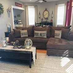 a living room filled with furniture and a large clock mounted to the side of the wall