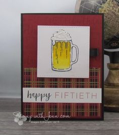 a close up of a card with a mug of beer on it and a globe in the background