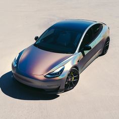 a silver car parked on top of a sandy beach