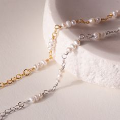 Our elegant and delicate Hali Pearl Station Bracelet is the ultimate accent to your bridal look. Give this minimalist charm bracelet as a gift to your bridesmaids or gift to yourself on the big day. Material: High Quality Solid 925 Sterling Silver Finish: Sterling Silver ∙ 18K Gold Featuring ~3-5mm Pearl Charms on a minimalist chain, adjustable 6 to 8 inches Part of the Casablanca Collection SKU: RR-BR038 Minimalist Pearl Bracelet With Adjustable Chain, Minimalist White Pearl Bracelet With Adjustable Chain, Dainty Personalized Silver Pearl Bracelet, Dainty Gold-plated Pearl Bracelet For Wedding, Dainty Gold-plated Pearl Bracelet With Adjustable Chain, Pave Heart Necklace, Minimalist Chain, Pearl Charm Bracelet, Station Bracelet