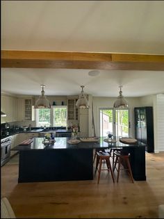 a large kitchen with an island in the middle