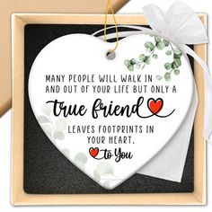 a heart shaped plaque with the words, many people will walk in and out of your life but only a true friend leaves footprints in your heart