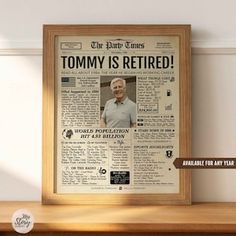 an old newspaper with the caption'tommy is retired'framed in a wooden frame