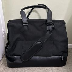 a black bag sitting on the floor next to a door