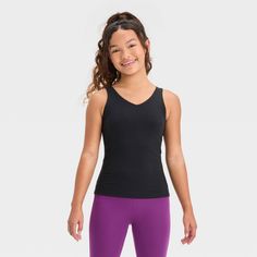 Why we're ALL IN: Solid-color athletic tank top with flat seams keeps them comfortable during any activity. Crafted from recycled polyester with spandex and a UPF 50+ rating to keep them feeling cool and fresh and shield them from the sun. Tailored in a fitted, below-hip length hip with a V-neck front and back for a sporty vibe. All in Motion™: Made for every move, priced for every day. Solid Sportswear Tank Top For Pilates, Sportswear Tank Top For Pilates, Compression Sleeveless Tops For Light Exercise, Compression Sleeveless Tank Top For Pilates, Summer Sportswear Tank Top For Pilates, Black Tank Top For Summer Pilates, Athletic Fit Sleeveless Tank Top For Pilates, Sleeveless Recycled Polyester Sports Bra For Gym, Stretch Sweat Resistant Tank Top For Yoga