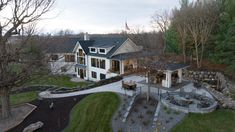 an aerial view of a large house in the woods