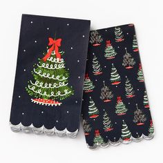 two napkins decorated with christmas trees and bows