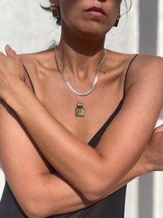 The Carmen Pendant Necklace is an absolutely stunning piece to wear with your favorite vintage blouses or an effortless slip dress. This distinctive square pendant is cast in brass & plated in 14k yellow gold and hangs on a delicate link chain. Strong enough when worn solo or layered with one's collection of keepsake pieces. We envision pairing this new arrival with the Mini Shell Pendant and our best selling Clarke Top Made in the USA Measurements: 1.14" pendant height 18" chain length Care Elegant Charm Necklace With Square Pendant And Clavicle Chain, Gold Charm Necklaces With Clavicle Chain And Square Pendant, Elegant Square Pendant Charm Necklace With Clavicle Chain, Gold Brass Necklace With Square Pendant, Luxury Vintage Square Pendant Necklace, Natalie Borton, Vintage Blouses, Knit Outerwear, Line Shopping