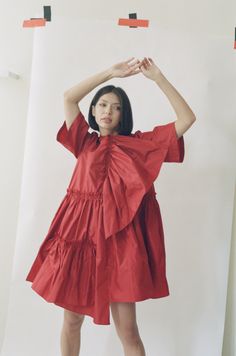 The Farfalle Babydoll Dress is a bold trapeze-cut dress in rich silk taffeta. A gathered silk panel on the bodice can be worn as a sculptural detail or a romantic cascading neckline. Raw edge ruffled seams, a dance-everywhere dressed up/down silhouette, finished with a delicate front pocket for stashing after-dinner mints. Loose billowing fit. Keyhole back closure. Pre-order only, ships late Summer 2022. Silk Dresses With Ruffles And Voluminous Skirt, Chic Ruffled Dresses For Gatherings, Red Ruched Dress For Daywear, Summer Taffeta Dress With Ruffles, A-line Taffeta Dress With Ruffles, Voluminous A-line Dress With Ruffles, Chic Taffeta Dress With Voluminous Skirt, Voluminous Ruched Silk Dresses, Pleated Bodice Taffeta Dress