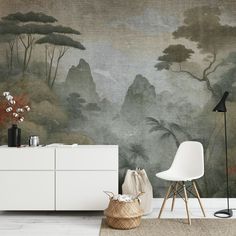 a room with a large painting on the wall next to a white cabinet and chair