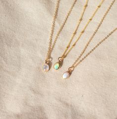 Our Dainty gemstone necklace features a tiny little stone, choose between opal, moonstone and turquoise.  DETAILS *PENDANT is Genuine Turquoise, Genuine Moonstone, or Synthetic Opal, measuring 5 x 7mm *CHAIN is 14k Gold Filled or Sterling Silver *CLASP is 14k Gold Filled or Sterling Silver Matching  PERSONALIZE IT!  ADD A STAR INITIAL CHARM: https://www.etsy.com/ca/listing/627638174/add-a-star-initial-charm ADD A STAMPED INITIAL: https://www.etsy.com/ca/listing/561708083/add-an-initial ADD A BIR Delicate Moonstone Necklace With Delicate Chain, Dainty Adjustable Moonstone Necklace, Delicate Moonstone Round Pendant Necklace, Delicate Round Moonstone Pendant Necklace, Dainty White Necklace With Moon Charm, Delicate Opal Jewelry With Birthstone, Delicate Opal Birthstone Jewelry, Minimalist Everyday Opal Jewelry, Dainty Moonstone Charm Necklace For Gift