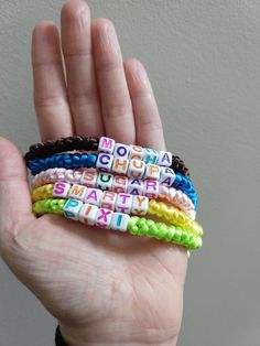 "If you're all about candy, this super sweet, candy-themed message bracelet mix is for your--or you and your 4 best friends! These 5 bracelets are hand-knotted on silky rat tail cord in beautiful bold colors.  Tell the whole world the way to your heart with these fun, eye-catching bracelets!  Each bracelet features adjustable sliding knot closure that will expand to a maximum of approximately 10 inches, plenty long to comfortably fit any wrist.  Specific details about each bracelet are as follows: 1 Pastel Pink \"SUGAR\" with Black knot 1 Chocolate Brown \"MOCHA\" with Acid Green knot  1 Acid Green \"PIXI\" with Fuchsia knot 1 Banana Yellow \"SMARTY\" with Royal Blue knot 1 Royal Blue \"CHUPA\" with Magenta knot Reminder:  This is a single-purchase set of 5, and the set includes all items 4 Best Friends, Sliding Knot Closure, Theme Words, Banana Yellow, Rat Tail, Message Bracelet, Candy Theme, Chunky Bracelets, Pink Sugar