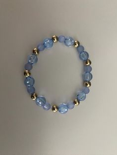 Gold and blue beaded bracelet Blue Stretch Bracelet With Polished Beads As Gift, Blue And Gold Beaded Bracelets, Elegant Blue Beaded Bracelets With Faceted Beads, Blue Beaded Bracelets With Polished Beads As Gift, Blue Polished Beads Bracelets For Gift, Elegant Blue Beaded Bracelet With Faceted Beads, Adjustable Blue Beaded Bracelets With Large Beads, Blue Round Beaded Bracelets With Faceted Beads, Light Blue Bracelets With Colorful Beads For Jewelry Making