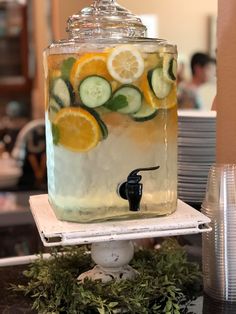 a glass jar filled with cucumbers and lemon slices