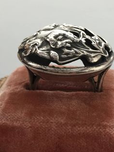 Gorgeous authentic ART NOUVEAU dome ring fashioned after the works of Alphonse Mucha. The ring features a beautiful woman with flowing hair surrounded by flowers and sinuous vines. The ring is heavy weighing 14.175 grams of silver. It is marked STERLING on the outside of the band. I did polish it a little because it was completely tarnished when I bought it but still retains much of the original patina. A great piece to wear or add to any vintage or antique jewelry collection. It is a woman's Si Vintage Silver Flower Ring For Jewelry Making, Handmade Victorian Metal Rings, Artistic Open Ring Jewelry For Wedding, Artistic Style Rings, Artistic Engraved Jewelry For Wedding, Artistic Hallmarked Jewelry For Formal Occasions, Antique Handmade Silver Rings, Art Nouveau Engraved Ring Jewelry, Artistic Engraved Formal Jewelry