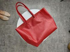 Overview: Design: Fashion Womens Red Leather Oversize Tote Bag Red Shoulder Tote Bag Handbag Tote For WomenIn Stock: Made to order (2-3 days)Include: Tote + A detachable Side InnerCustom: NoColor: RedLeather: CowhideMeasures: Horizontal Style S: 46cm/Bottom 34cm x 30cm x 14cmHorizontal Style L: 50cm/Bottom 37cm x 33cm x 16cm Vertical Style S: 41cm/Bottom 33cm x 35cm x 11cm Vertical Style L: 47cm/Bottom 37cm x 40cm x 11cmWeight: 0.75 kgSlots: 1 slotAccessories(option): NoStyle: Tote Bag, Shoulder Burgundy Large Capacity Bag For Shopping, Red Rectangular Box Bag For Travel, Red Large Capacity Box Bag For Travel, Red Rectangular Bag With Large Capacity, Burgundy Hobo Bag With Large Capacity For Shopping, Red Tote Box Bag For Office, Red Rectangular Shoulder Bag For Travel, Red Top Handle Box Bag For Office, Large Capacity Burgundy Hobo Bag For Shopping