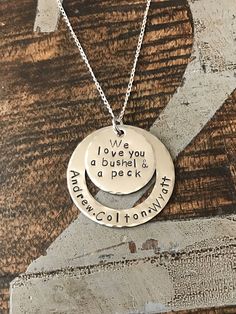 "Mom Necklace Mothers Day Gift Love you a Bushel & a Peck Necklace New Mom Gift Handstamped Necklace Personalized Jewelry Quote Necklace Grandma Necklace *\"We love you a Bushel & a Peck\" handstamped necklace with child's names. This necklace makes a loving gift to any member of your family or friends. * A 1\" Stainless Steel disc stamped with \"Bushel & Peck\" quote * A 1.5\" Stainless Steel Washer stamped with \"names\" of choice(up to 6) * A 18\" in Sterling Silver Plated chain a Meaningful Stamped Necklace For Mother's Day, Meaningful Stamped Necklaces For Mother's Day, Meaningful Hand Stamped Jewelry For Mother's Day, Hand Stamped Sterling Silver Necklaces For Father's Day, Stamped Necklaces For Valentine's Day Gift, Stamped Pendant Necklace For Valentine's Day, Stamped Pendant Necklaces For Valentine's Day, Valentine's Day Gift Necklace, Meaningful Stamped Charm Necklaces For Mother's Day