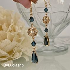 Elevate your elegance with our gold-plated Art Deco earrings: a combination of timeless sophistication and contemporary charm. The navy blue teardrop-shaped crystals hang gracefully, creating a fascinating play of light that is sure to catch everyone's eye. Blue crystal bicones complete this wonderful look. Something Blue takes on a whole new meaning with these earrings, making them the perfect choice for brides looking to incorporate a touch of tradition and style. The earrings provide comfort Gold And Blue Earrings, Blue Earrings Aesthetic, Vintage Blue Drop Earrings Jewelry, Elegant Blue Crystal Earrings, Art Deco Blue Drop Earrings, Ornate Blue Dangle Earrings, Blue Gemstone-accented Earrings For Formal Occasions, Navy Earrings, Shaped Crystals