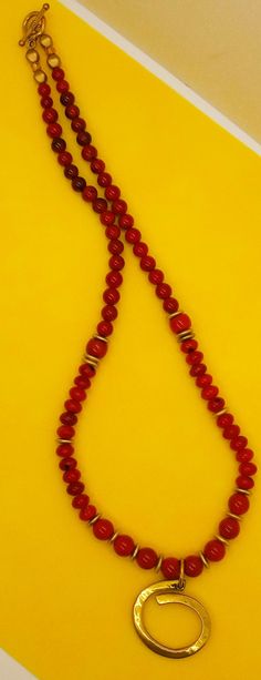 Beautiful Large 10-12 mm Red Coral Beads with Boho Brass Pendant. Matte Brass Accents throughout the necklace accentuate the Pendant nicely. Red Coral Spiritual Necklaces, Spiritual Red Coral Necklaces, Spiritual Red Coral Necklace, Red Coral Jewelry With 8mm Beads, Red Polished Beads Round Jewelry, Traditional Red Coral Jewelry With Wooden Beads, Red 8mm Beads Jewelry For Meditation, Traditional Red Coral Beads, Spiritual Round Necklaces For Festive Occasions