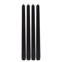 three black candles sitting next to each other