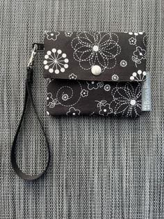 This petite women's minimalist small wristlet wallet is perfectly sized for credit cards (RFID protected), IDs or business cards, featuring one card pocket in front and one behind the zippered change pocket. The snapped fold-over closure allows for easy access, but still keeps your items secure. Slim and compact, this wallet easily slips into your handbag or pocket. The Small Wallet is made from high quality designer cotton fabrics that are adhered to a lightweight interfacing. This gives it a durable and structure.  More about RFID Fabric: This wallet has a Radio Frequency Blocking fabric sewn inside so your personal information cannot be stolen using scanners. The RFID fabric inside the wallet blocks radio waves and thereby preventing thieves from accessing your private information (incl Business Card Holder Wallet, Fabric Wallet, Credit Card Wallet, Wristlet Wallet, Slim Wallet, Minimalist Wallet, Clip Wallet, Small Wallet, Card Holder Wallet