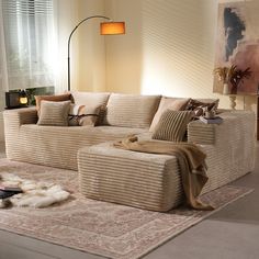 a living room filled with furniture and a rug on top of a carpeted floor