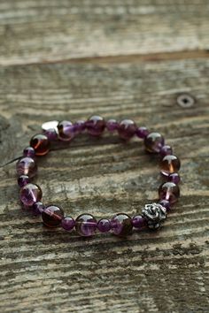 It is a perfect gift for your loved ones since it is a hand-made natural gemstone bracelet. It is a genuine Amethyst gemstone and handmade 925 sterling silver dragon head and Brand tag bracelet.  WE OFFER 100% NATURAL GEMSTONES CARVED FROM RAW STONES WHICH MAKES OUR PRODUCTS OF THE BEST QUALITY. We are small family jewelers located in Latvia, Europe, and we are proud that in our products, we use only genuine, natural, and unique gemstones. We spend so much time working with every single piece of gemstone and guarantee uniqueness and quality. About the Item Bracelet size: 19cm/7.5inch - We make/adjust the size you need. Amethyst beads size: 10mm and 6mm Material: Genuine unenhanced no dyed hand-carved from raw stone natural Amethyst. Amethyst Chakra: Crown Chakra. The Amethyst stone bracele Spiritual Sterling Silver Bracelet With Purple Gemstone, Sterling Silver Amethyst Bracelet Gift, Spiritual Purple Sterling Silver Bracelet, Spiritual Purple Gemstone Sterling Silver Bracelet, Faceted Amethyst Crystal Bracelet Gift, Rondelle Amethyst Bracelet With Natural Stones, Sterling Silver Crystal Bracelet With Round Beads For Healing, Spiritual Stretch Bracelet With Faceted Details As Gift, Spiritual Stretch Bracelet With Facets As Gift