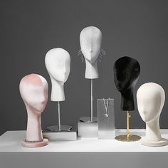 five different types of mannequin heads on display