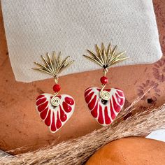 We combine art and elegance to create this beautiful piece. Our handmade earrings will be the perfect element to make your outfit standout. You could have the entire collection or gift them to someone special.  Material: Real Gold plate brass, Talavera gemstone  Dimensions: Drop Length 3cm, weight 2g Features : Lightweight, Unique and Simple design The Talavera of Puebla is part of the intangible heritage of humanity, declared by UNESCO. It is a type of majolica ceramic with a mixture of Chinese, Italian, Spanish, and indigenous techniques, and its colors are obtained from natural pigments. Its main characteristics are its vitreous finish and the use of bulky cobalt blue, this made it even more exclusive and ostentatious than Spanish craftsmanship. Its production requires at least 120 hour Handmade Festive Jewelry For Valentine's Day, Hand Painted Gold Jewelry Gift, Gold Hand Painted Jewelry Gift, Red Gold-plated Pierced Jewelry, Handmade Heart-shaped Gold Plated Jewelry, Artistic Heart Earrings As Gift, Elegant Handmade Earrings For Valentine's Day, Bohemian Red Beaded Earrings Gift, Artisan Heart Earrings As Gift