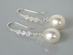 A stunning and elegant pair of dangle hook earring.  Approximately 10.5mm x 9.5mm half drilled white drop pearls with very good lustre. AAA quality freshwater pearls and Sterling silver hooks with cubic zirconia setting.  The earrings is approximately 3.8cm long.  The pearls are genuine freshwater pearls therefore each pearl is slightly different in shape and size with it own unique natural blemishes. The colour of the actual earrings might be slightly different to the photo due to the lighting Silver Pearl Earrings With French Hook For Formal Occasions, Silver Pearl Earrings With French Hook For Formal Events, Elegant Sterling Silver Pearl Earrings With Ear Wire, Elegant Silver Pearl Earrings With French Hook, Drop Pearl Earrings With French Hook For Wedding, French Hook Pearl Drop Earrings For Wedding, Elegant Pearl Earrings With French Hook For Wedding, Wedding Pearl Drop Earrings With French Hook, Silver French Hook Jewelry For Wedding