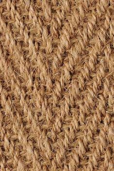 close up view of the crochet pattern on an area rug that looks like woven fabric