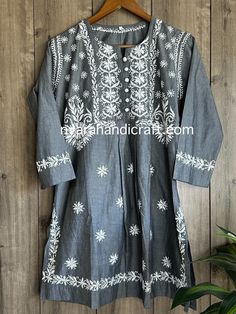 Unique denim look Chikankari hand embroidered blouse with side slits. Length: 32 inches Spring Cotton Kurta With Motifs, Casual Fitted Kurta With Floral Embroidery, Cotton Straight Kurta With Chikankari Embroidery, Cotton Chikankari Embroidered Long Sleeve Top, Casual Cotton Kurta With Embroidery, Casual Cotton Embroidered Kurta, Traditional Cotton Embroidered Tunic Top, Traditional Embroidered Cotton Tunic Top, Traditional Cotton Top For Eid