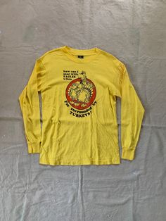 Vintage long sleeve tee with funny graphic and quote, in overall good condition with some faint staining on left sleeve. Fits like a modern Medium Pit to pit 19" Length 26" PLEASE READ! *MEASUREMENTS* All items are measured while laying flat and unstretched. For clothing: chest, waist, hip and thigh measurements should be multiplied by two. All measurements are in inches. *VINTAGE CONDITION* Vintage goods may show signs of wear and age. We always indicate and/or show in pictures any major flaws or blemishes, but will not always mention small flaws, such as pinpoint sized spots or holes. If you are concerned about a particular item's condition, please message us. All of our pieces are pre-owned. We use a natural detergent to wash all our textiles when necessary (with a few exceptions such a Natural Detergent, Funny Graphics, Funny Quote, 1980s Vintage, Workout Tee, Vintage Tees, Long Sleeve Tee, Vintage 70s, Made In Usa