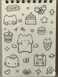 an open notebook with doodles on it and various items drawn in the style of hello kitty