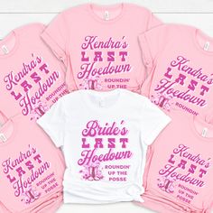 the bride's t - shirts are pink and white with purple lettering on them