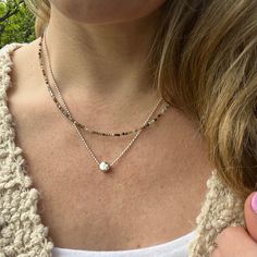 This simple circle charm necklace is the perfect minimalist every day jewelry. The elegant sterling silver dot charm floats on a sterling silver bead chain for a great feminine classy look. Sterling Silver Focal Bead - 6mm Choose your length at checkout! Model is wearing 18 inches Jasper Necklace as shown in photos: https://www.etsy.com/listing/1471325157/layering-necklace-fancy-jasper-beaded?click_key=e2a7461b0b24e4766d5ab61279a7dbfaeb15f0e2%3A1471325157&click_sum=26b804b0&ref=shop_home_active_1&pro=1&frs=1 To view more of my original jewelry designs, visit: https://www.etsy.com/shop/TheBeadCounter Sterling Silver Charm Necklaces For Layering, Sterling Silver Round Charm Necklaces For Layering, Minimalist Round Bead Charm Necklace As Gift, Sterling Silver Charm Necklaces With Round Beads, Silver Charm Necklace With Round Pendant And Satellite Chain, Minimalist Double Strand Charm Necklace, Silver Charm Necklace With Satellite Chain, Silver Dainty Charm Necklace For Layering, Minimalist Silver Beads Round Jewelry