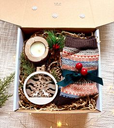 an open box filled with christmas items on top of a table