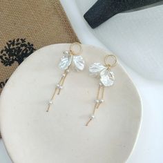 Check out our bow shaped pearl tassel earrings. Such an elegant pair of earrings, that would be perfect for just the right outfit. Elegant White Tassel Earrings For Pierced Ears, Elegant Dangle Tassel Earrings For Pierced Ears, Chic White Earrings With Pearl Chain, Elegant Tassel Dangle Earrings For Pierced Ears, Chic Pearl Drop Chandelier Earrings For Gift, Chic Chandelier Earrings With Pearl Drop, Chic Chandelier Earrings With Pearl Drop As Gift, Chic White Pearl Chain Earrings, Chic White Pearl Earrings With Pearl Chain