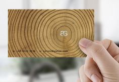 a person holding up a business card with the letter s on it