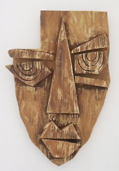 a wooden mask with two eyes on it